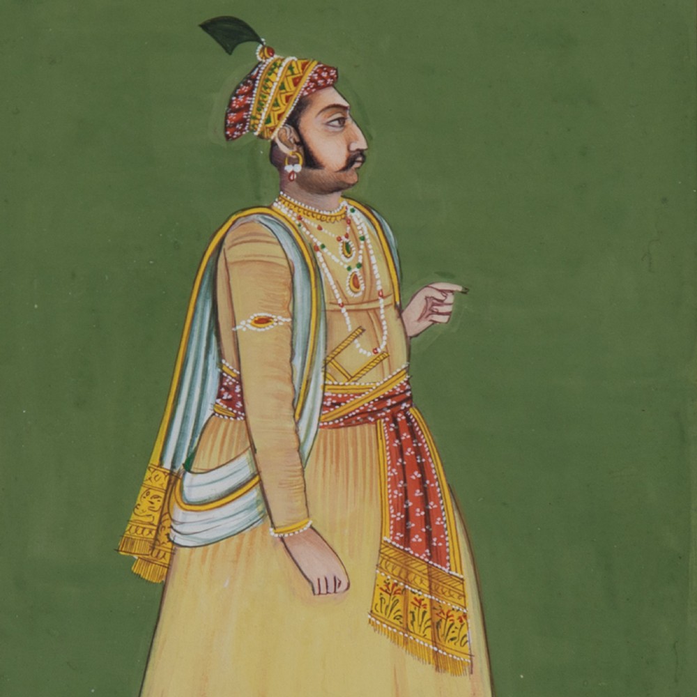 A framed Indian miniature portrait depicting a nobleman in traditional yellow attire standing against a green background with decorative painted borders. View II