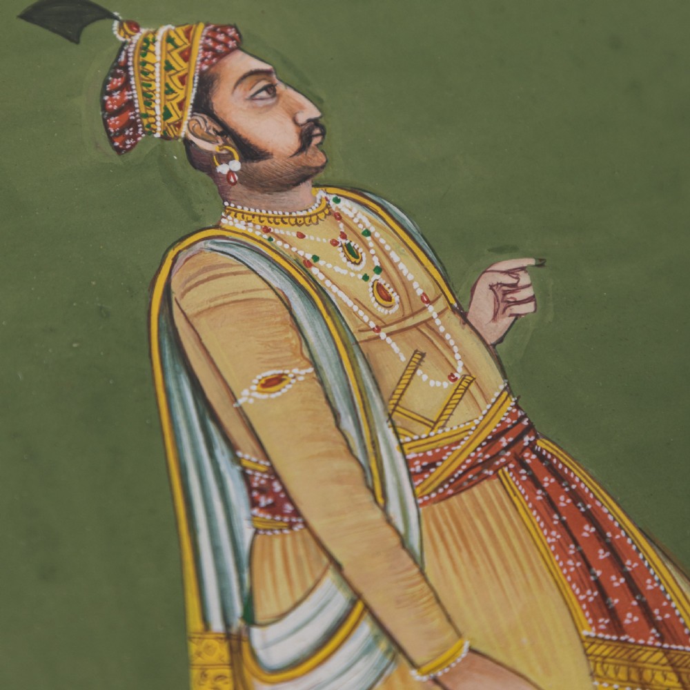 A framed Indian miniature portrait depicting a nobleman in traditional yellow attire standing against a green background with decorative painted borders. View III