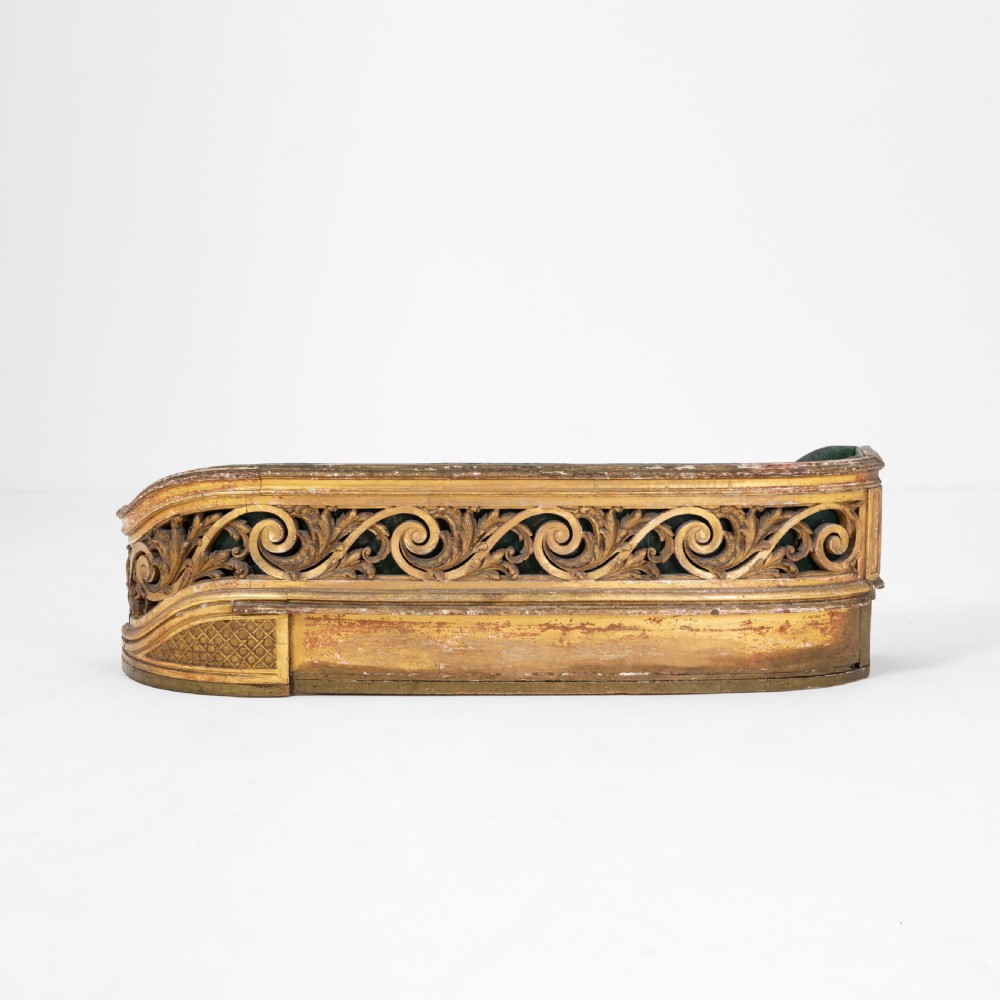 A 19th-century carved giltwood jardiniere featuring pierced scrolling acanthus motifs and a low curved profile.