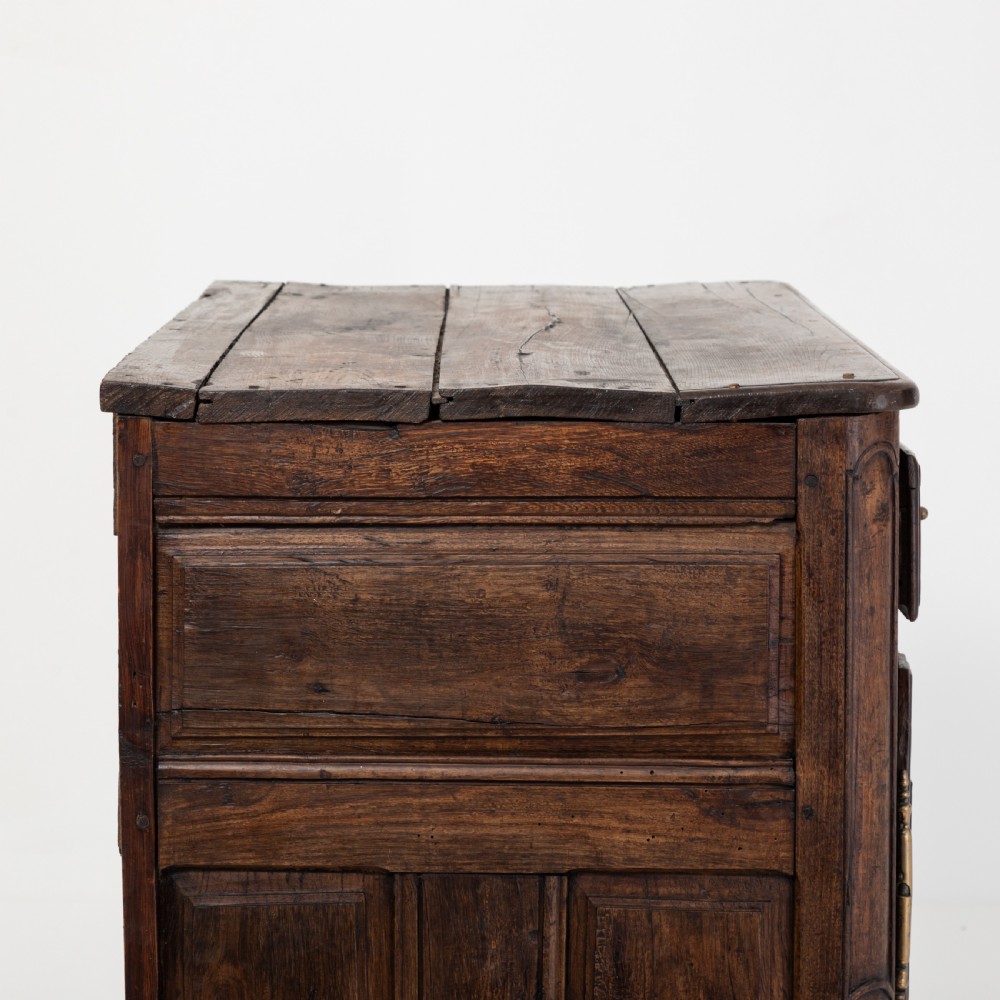 An eighteenth-century Louis XV period dark oak buffet featuring two panelled cabinet doors, three upper drawers, ornate brass hardware, and a shaped apron. View VI