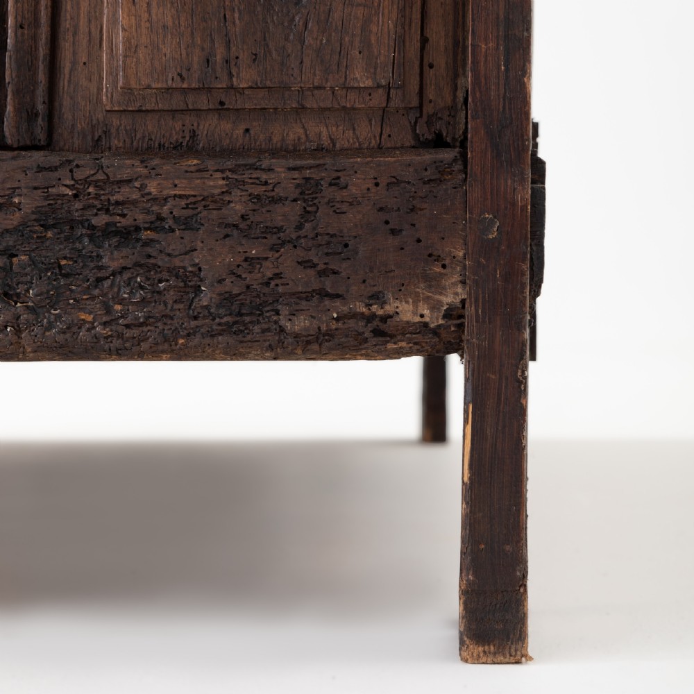 An eighteenth-century Louis XV period dark oak buffet featuring two panelled cabinet doors, three upper drawers, ornate brass hardware, and a shaped apron. View XI