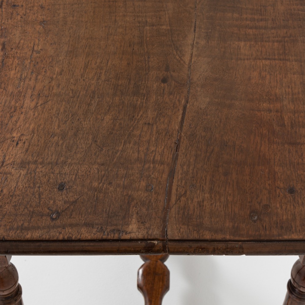 A 17th-century Welsh oak tavern table with turned legs, a single drawer, and an H-stretcher base. View VI