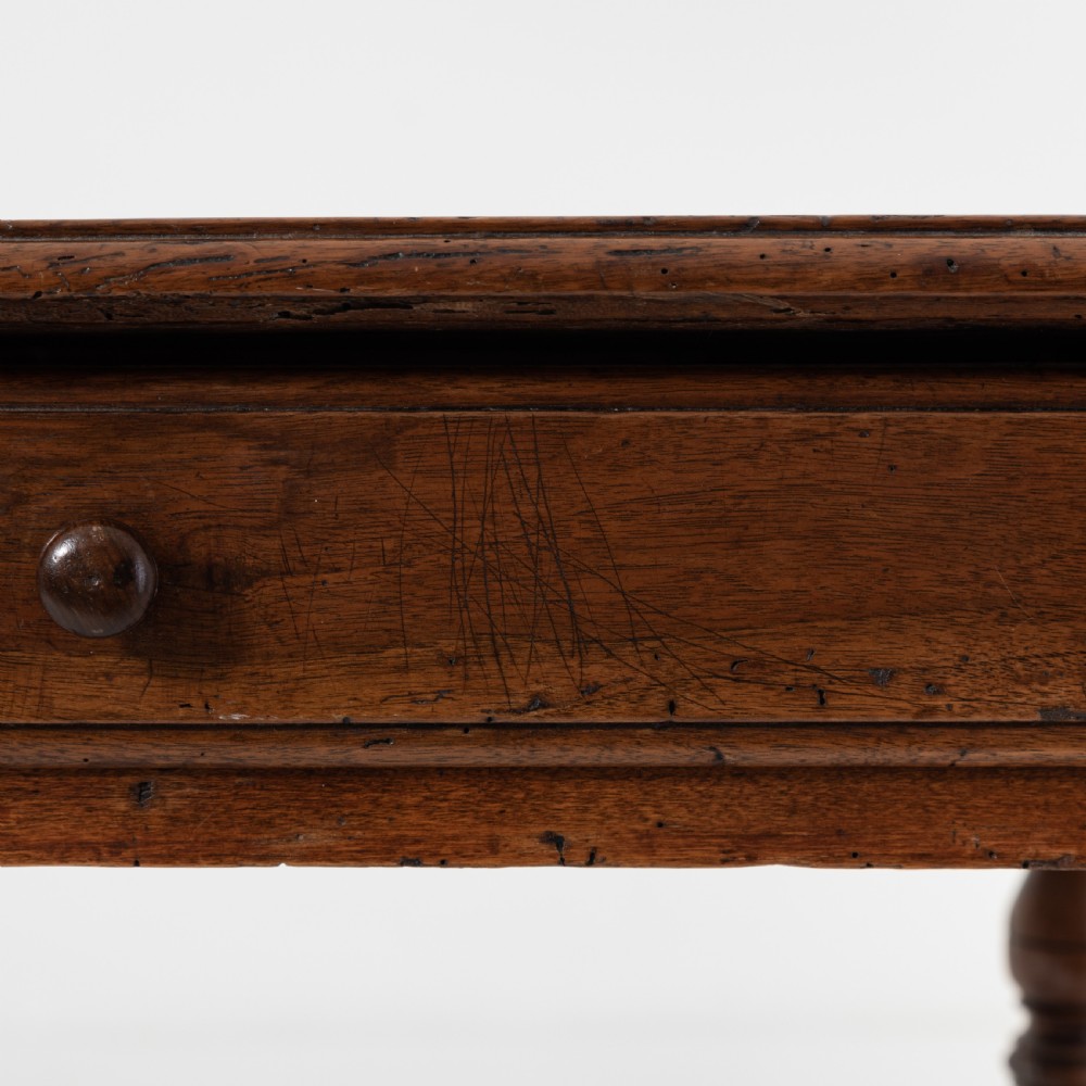 A 17th-century Welsh oak tavern table with turned legs, a single drawer, and an H-stretcher base. View VII