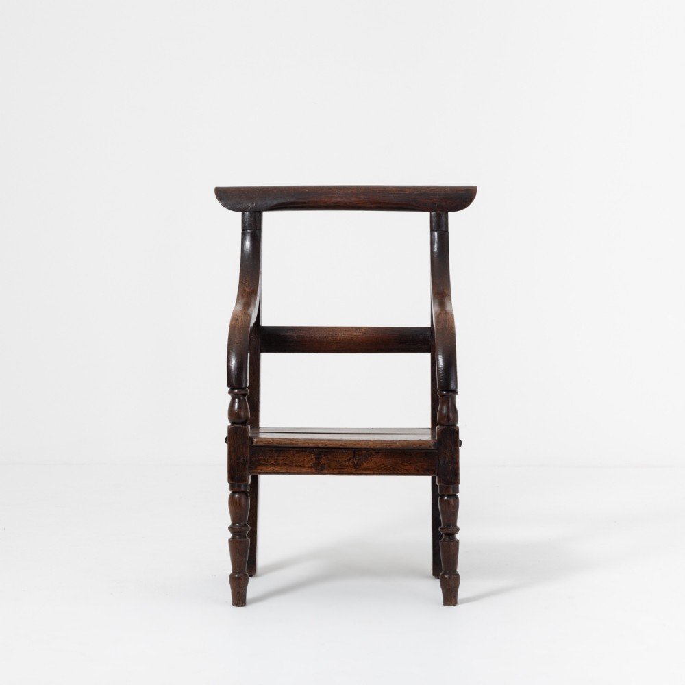 A dark brown 19th-century oak and elm armchair featuring turned front legs, curved arm supports, and a flat top crest rail. View IV