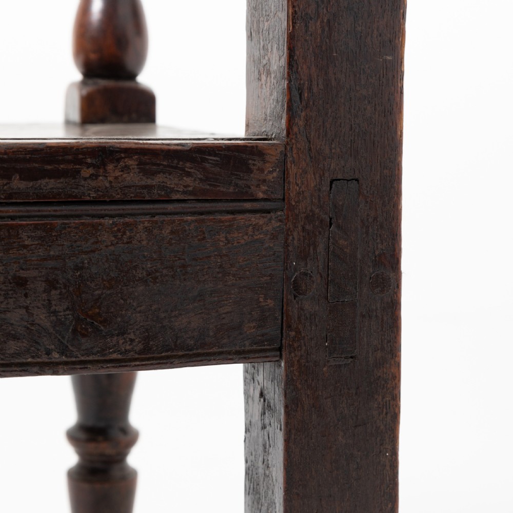A dark brown 19th-century oak and elm armchair featuring turned front legs, curved arm supports, and a flat top crest rail. View IX
