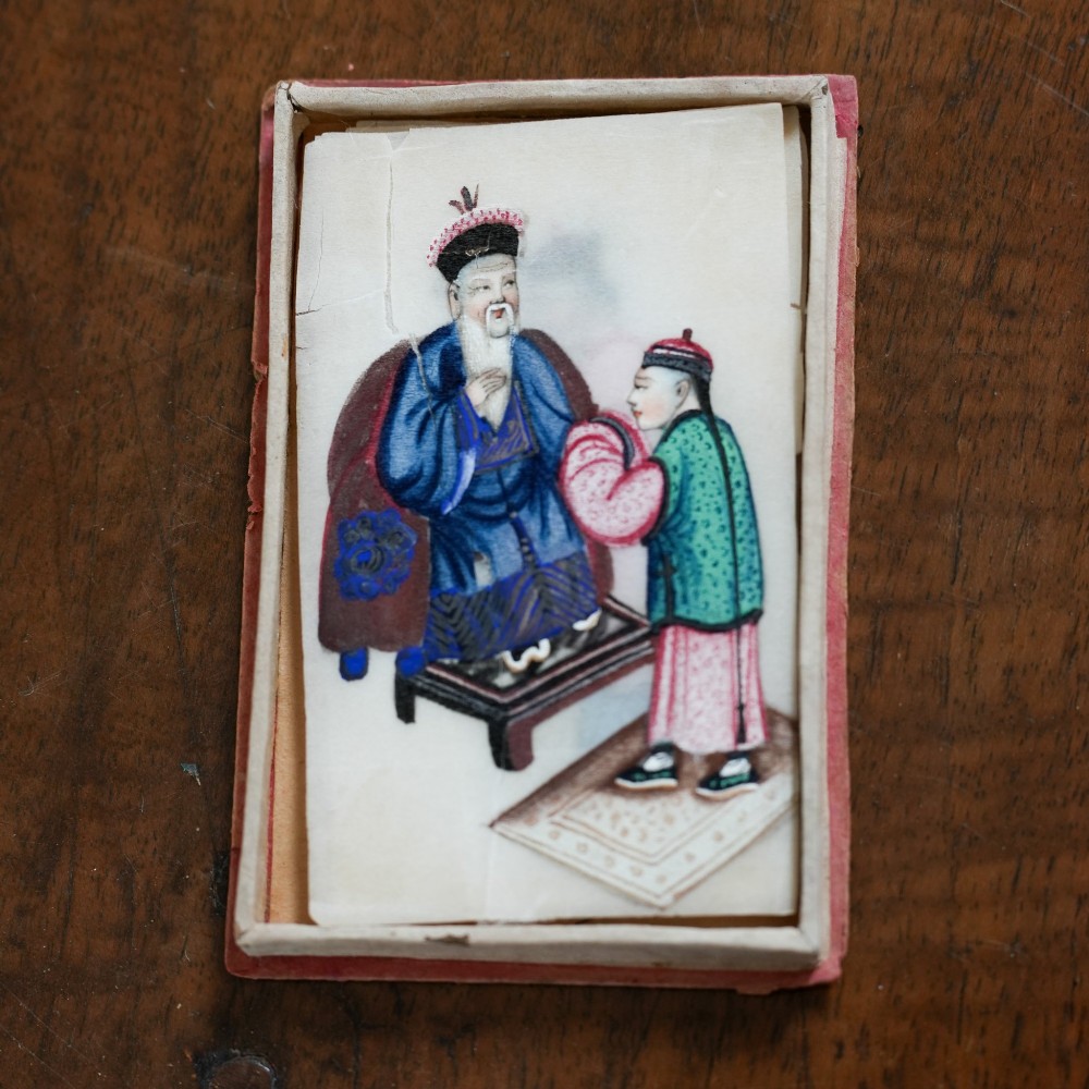 A set of twelve 19th-century Chinese pith paper paintings depicting various figures in traditional Qing dynasty attire playing musical instruments and holding cultural objects. View VII
