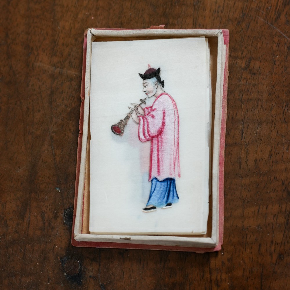 A set of twelve 19th-century Chinese pith paper paintings depicting various figures in traditional Qing dynasty attire playing musical instruments and holding cultural objects. View VIII