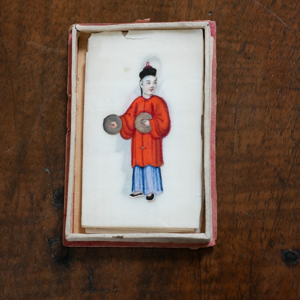 A set of twelve 19th-century Chinese pith paper paintings depicting various figures in traditional Qing dynasty attire playing musical instruments and holding cultural objects. View IX