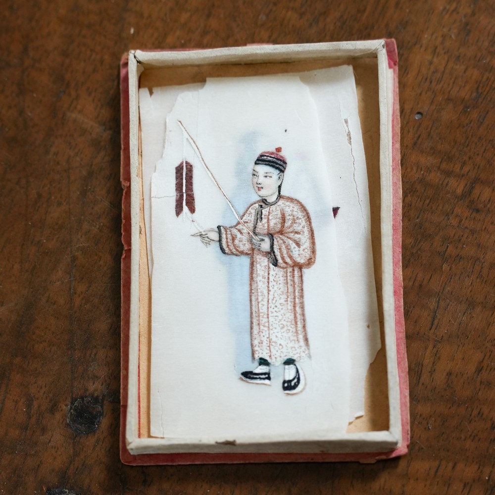 A set of twelve 19th-century Chinese pith paper paintings depicting various figures in traditional Qing dynasty attire playing musical instruments and holding cultural objects. View XII
