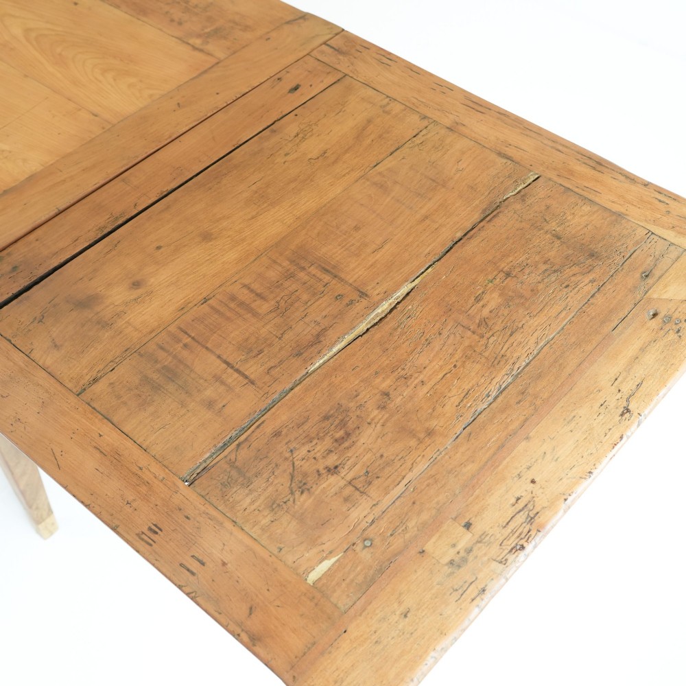 A nineteenth-century French provincial fruitwood dining table featuring square tapered legs, a single frieze drawer, and a draw-leaf extension system. View VII