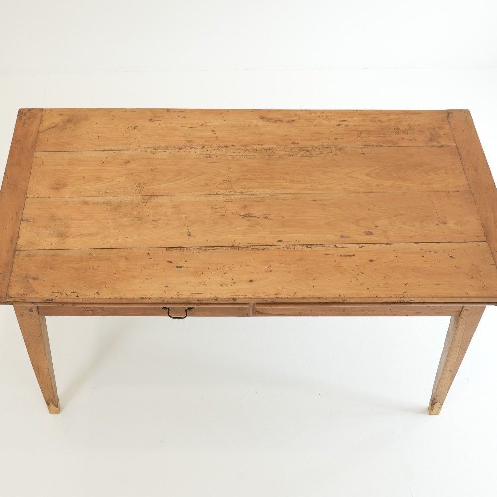 A nineteenth-century French provincial fruitwood dining table featuring square tapered legs, a single frieze drawer, and a draw-leaf extension system. View XI