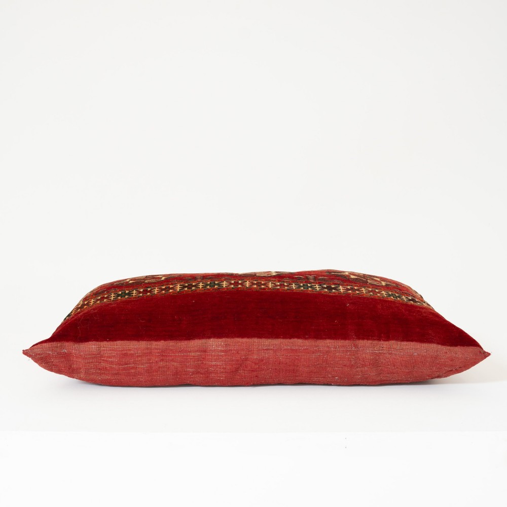 A rectangular hand-woven wool cushion featuring geometric Turkmen gul patterns in deep red, cream, and dark brown. View II