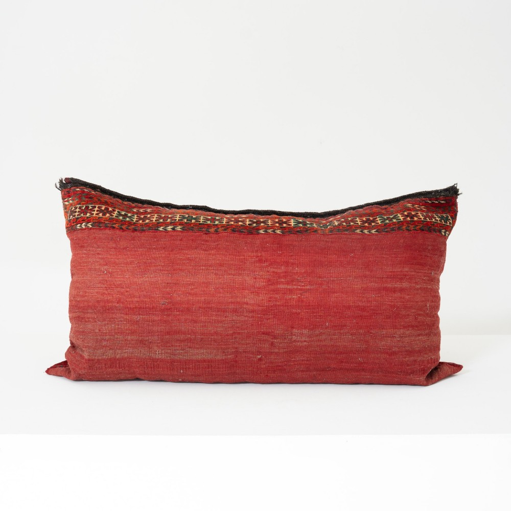 A rectangular hand-woven wool cushion featuring geometric Turkmen gul patterns in deep red, cream, and dark brown. View III