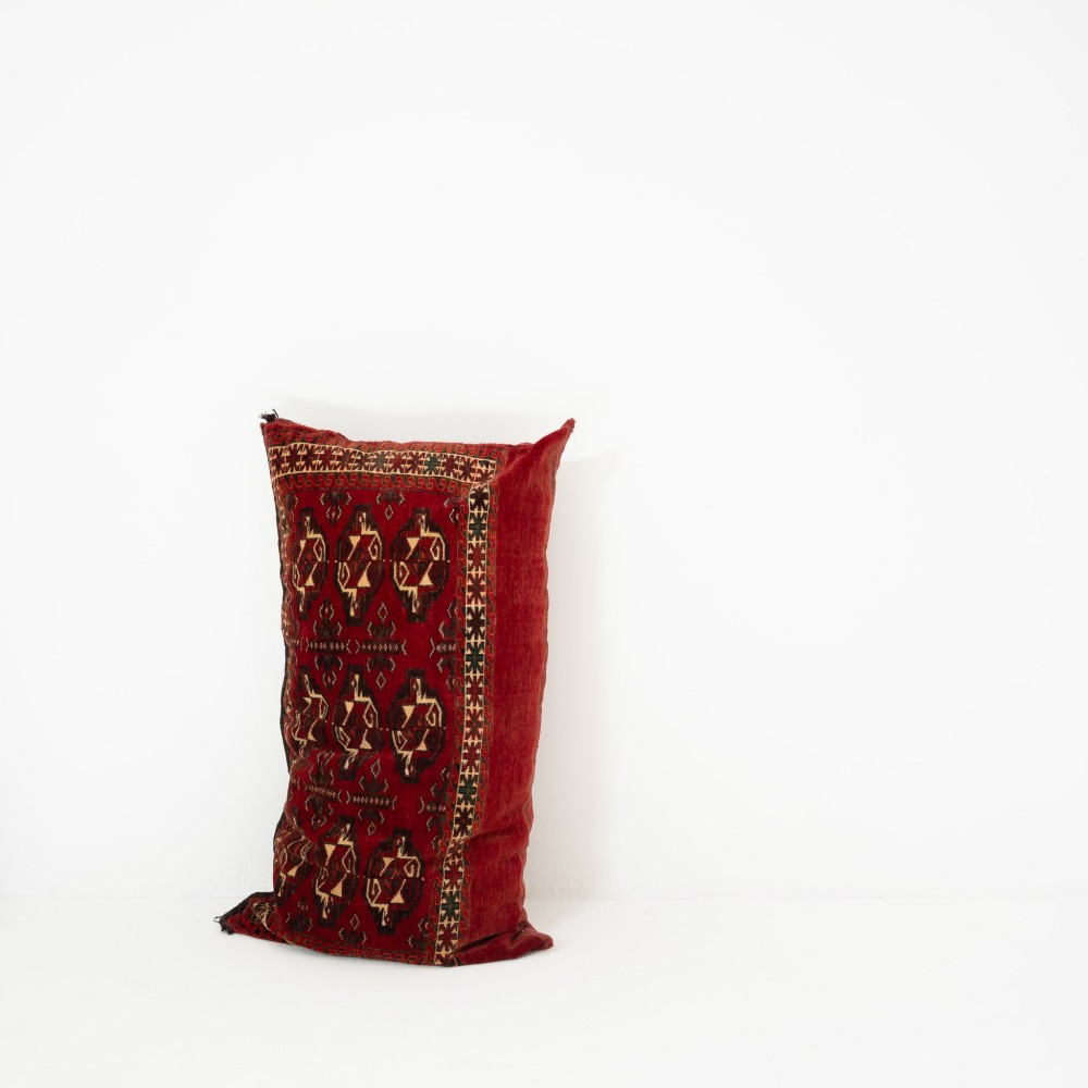 A rectangular hand-woven wool cushion featuring geometric Turkmen gul patterns in deep red, cream, and dark brown. View IV