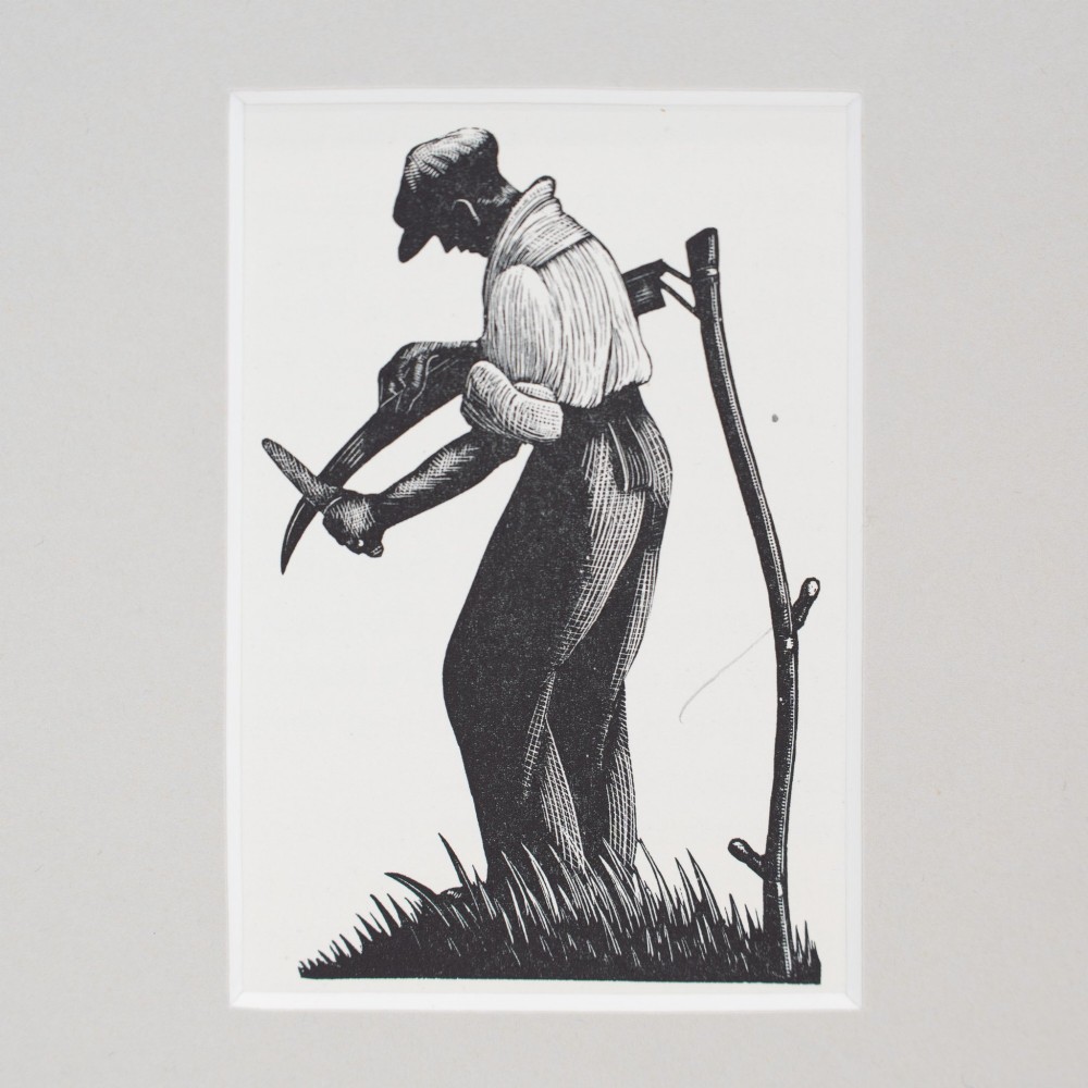 A monochrome wood engraving depicting a figure sharpening a scythe outdoors, presented within a wide neutral card mount. View II