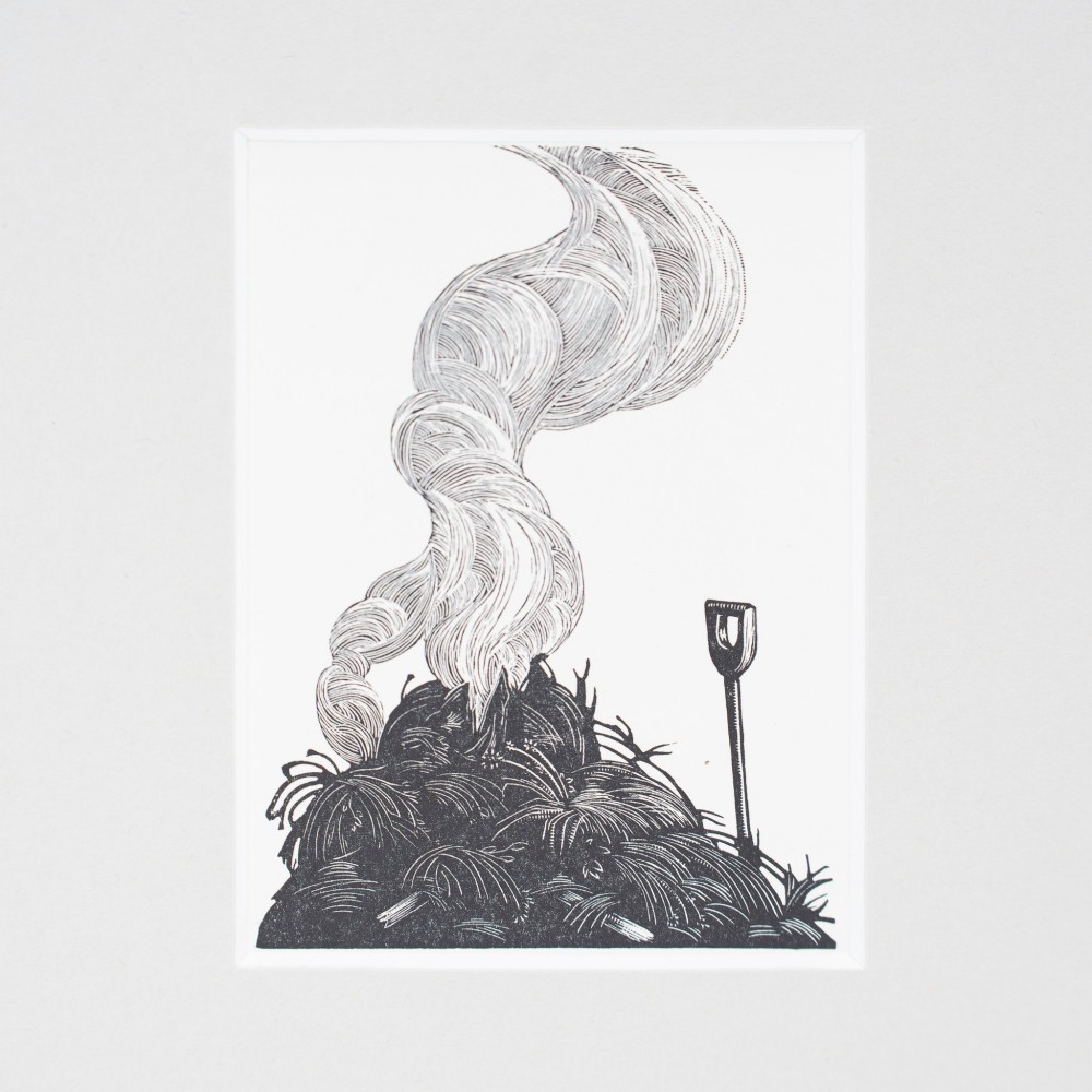 A monochrome wood engraving depicting a garden bonfire with a plume of smoke curling upwards beside an upright spade, presented in a light grey mount. View II