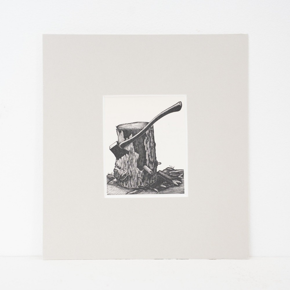 A monochrome wood engraving depicting an axe stuck into a wooden chopping block, presented in a square neutral mount.