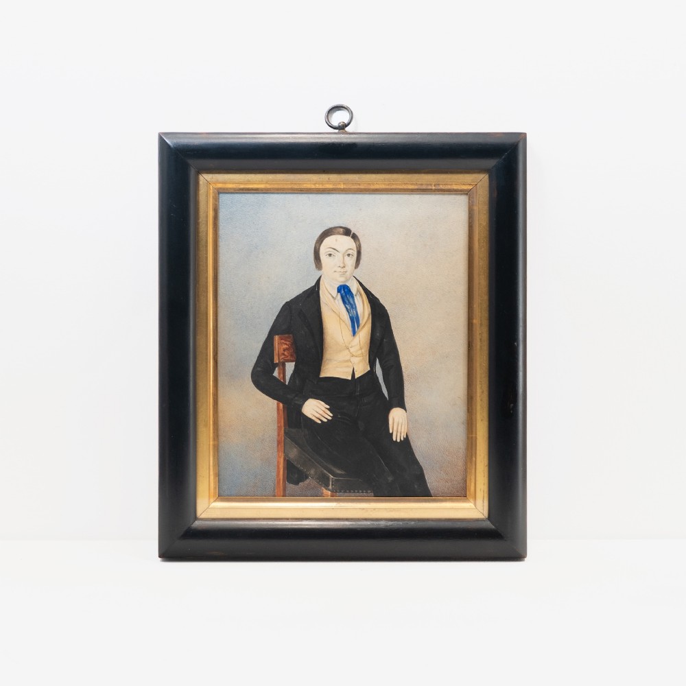 A pair of mid-19th century framed folk art portraits depicting a seated woman and man in period clothing. View II