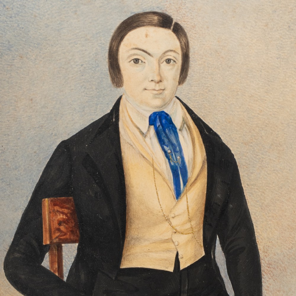 A pair of mid-19th century framed folk art portraits depicting a seated woman and man in period clothing. View V