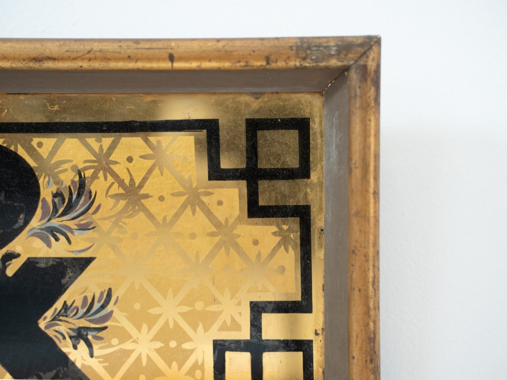 A long rectangular late Victorian verre eglomise glass shop sign framed in gold timber, displaying bold black lettering reading CHEMIST & on a gilded background. View VII