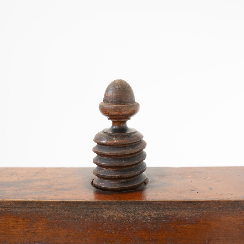 A Victorian mahogany and pine linen press featuring a central wooden screw mechanism over two small drawers with turned black knobs and four square legs. View XIII
