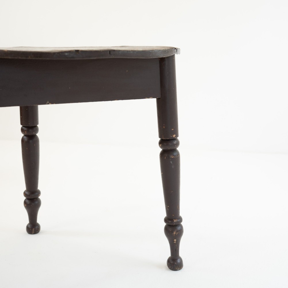 A 19th-century circular pine cricket table featuring a dark painted finish and three turned legs. View VI
