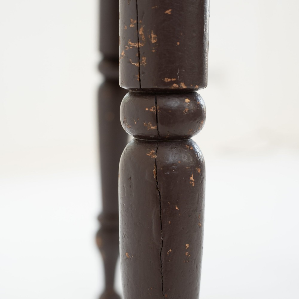 A 19th-century circular pine cricket table featuring a dark painted finish and three turned legs. View IX