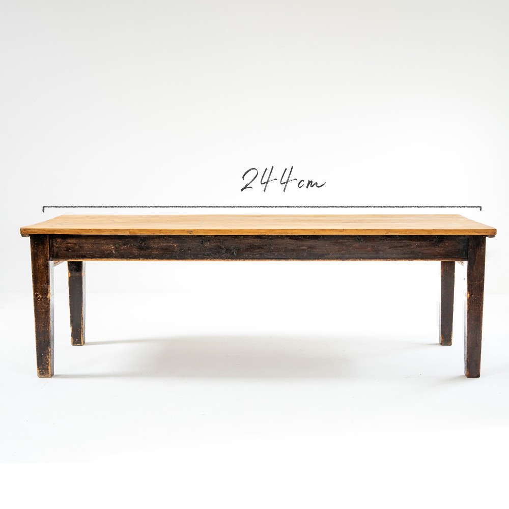 An eight-foot long Victorian pine harvest table featuring a natural timber top surface, a distressed black painted apron, and tapered square legs. View II