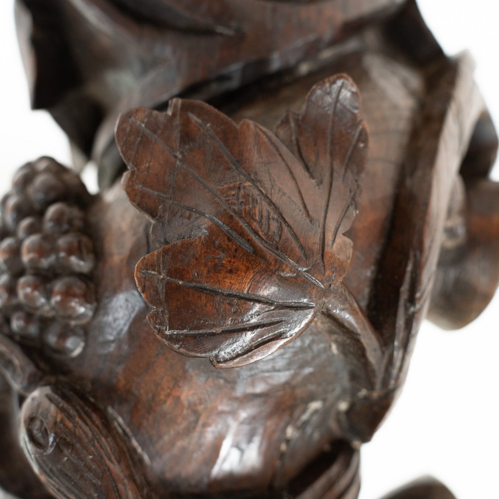 A dark carved oak Solomonic pedestal column with a spiralled grapevine shaft, Corinthian capital, and stepped square base. View VIII