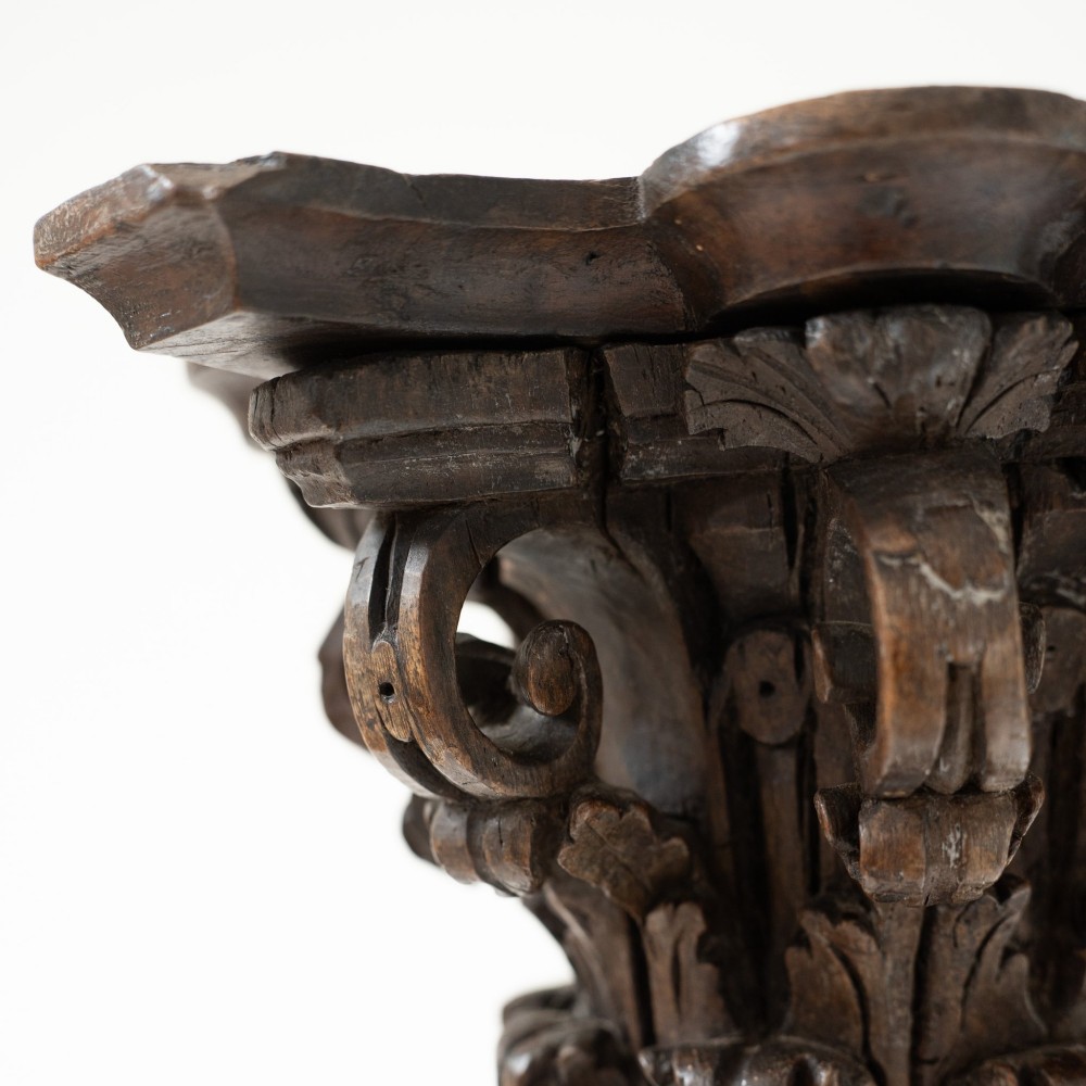 A dark carved oak Solomonic pedestal column with a spiralled grapevine shaft, Corinthian capital, and stepped square base. View X