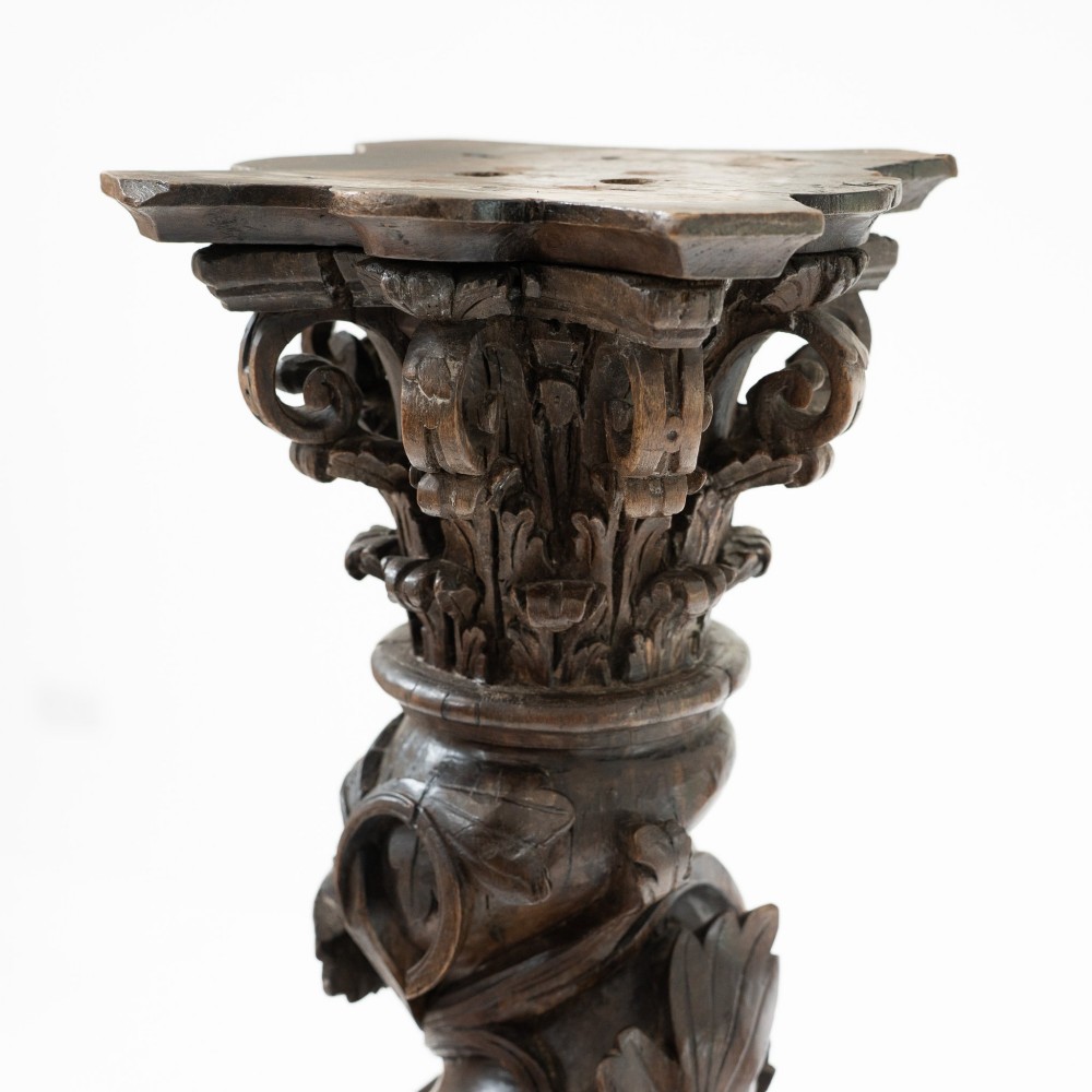 A dark carved oak Solomonic pedestal column with a spiralled grapevine shaft, Corinthian capital, and stepped square base. View XII