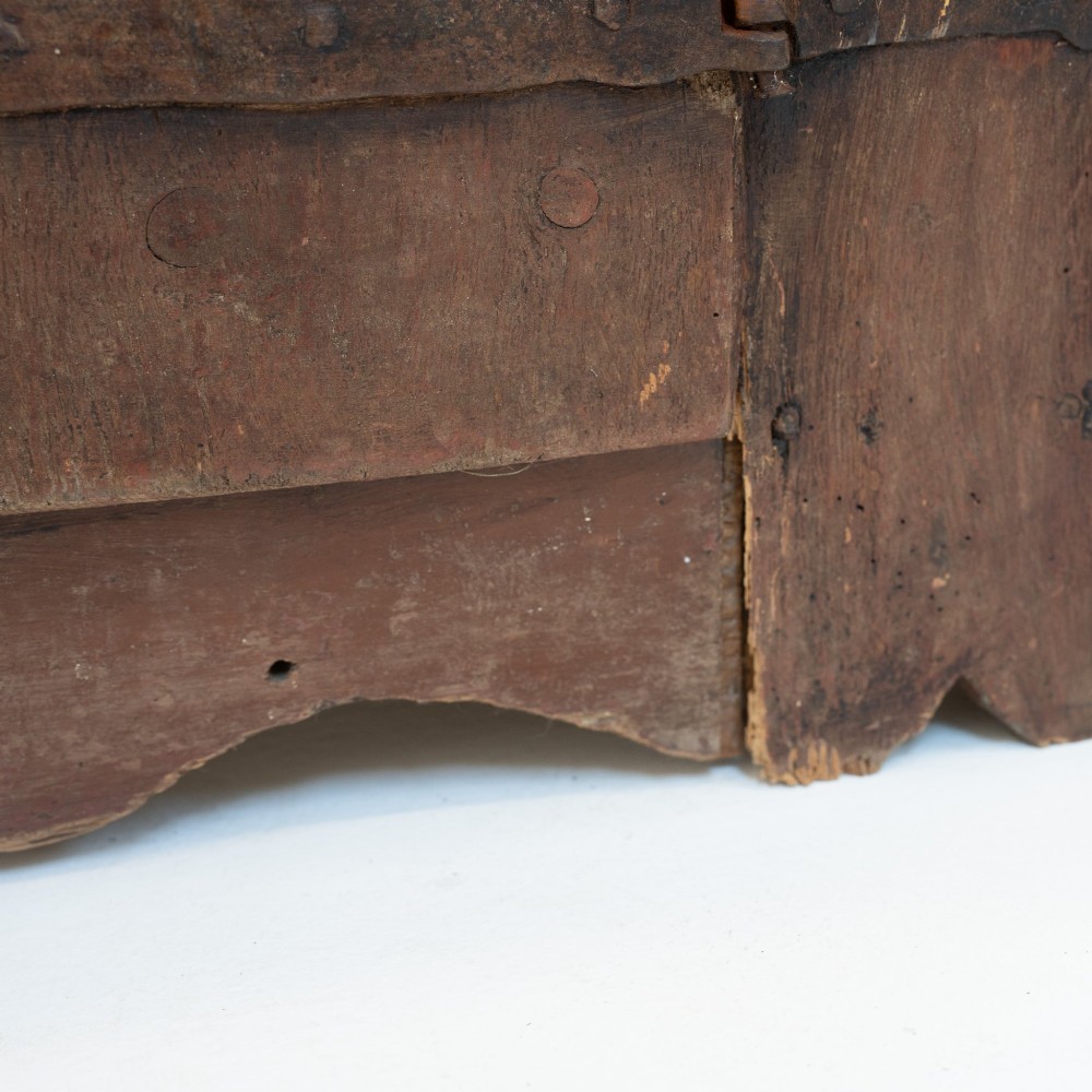 A late eighteenth-century dark timber Irish kitchen dresser featuring open plate shelves with scalloped sides above a single-door cupboard base with wrought iron hinges. View XIII