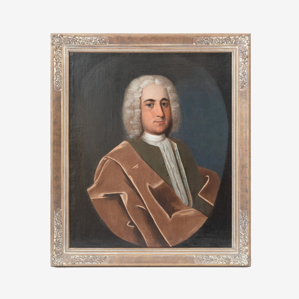 An 18th-century oil portrait on canvas depicting a gentleman in a powdered wig, white cravat, and draped brown mantle, presented in an ornate gilt frame.