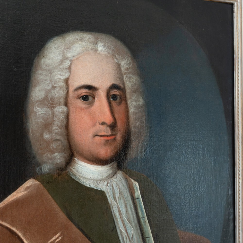 An 18th-century oil portrait on canvas depicting a gentleman in a powdered wig, white cravat, and draped brown mantle, presented in an ornate gilt frame. View VI