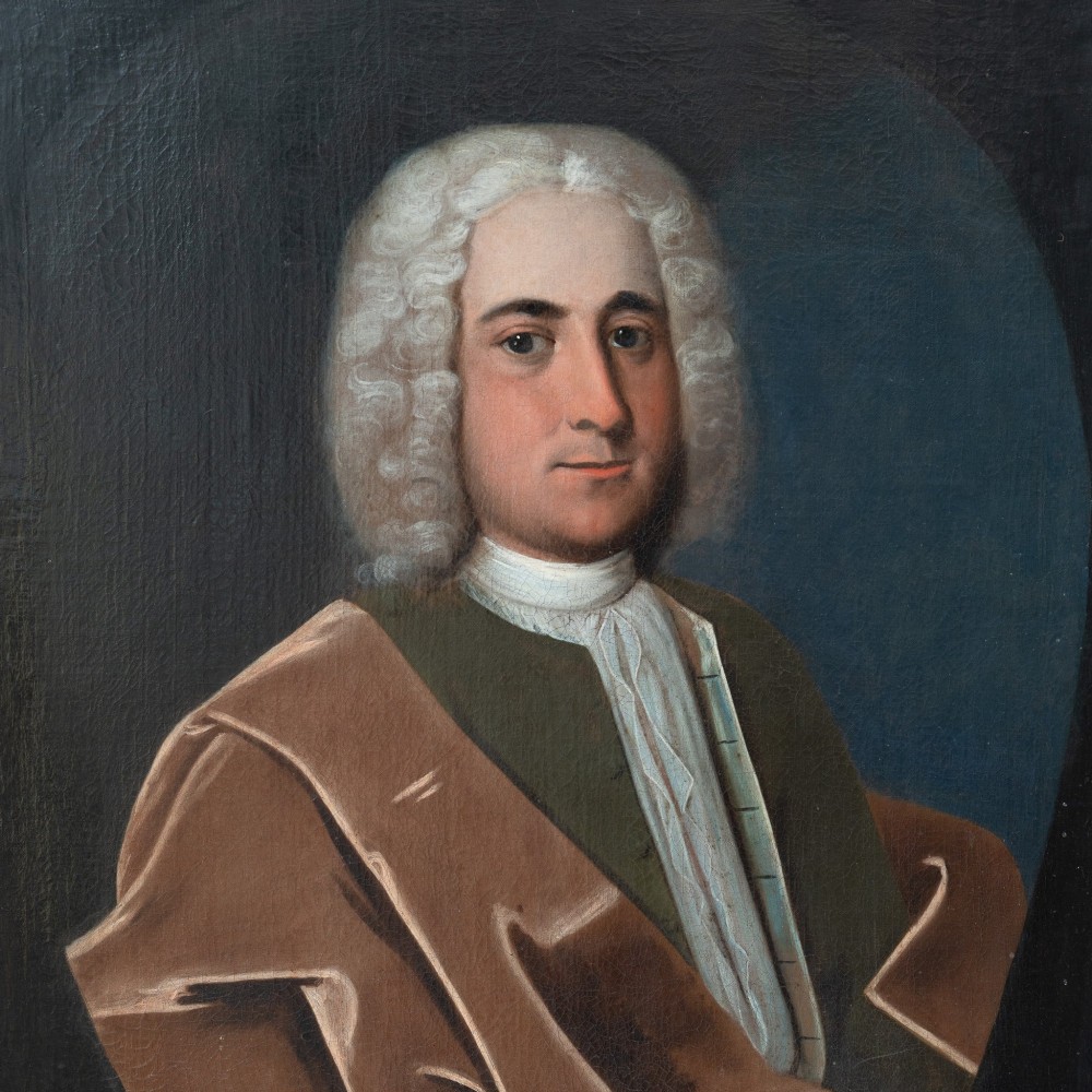 An 18th-century oil portrait on canvas depicting a gentleman in a powdered wig, white cravat, and draped brown mantle, presented in an ornate gilt frame. View VIII