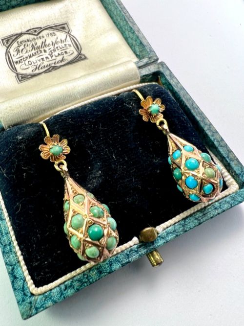 fig 1. A pair of Victorian gold drop earrings featuring floral tops and lattice-engraved teardrop pendants set with turquoise cabochon stones.