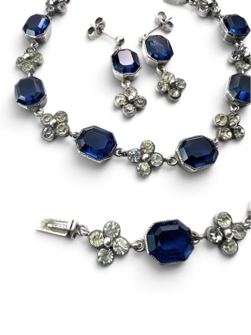 fig 1. An Art Deco silver jewellery set comprising a link necklace and drop earrings with octagonal blue paste stones and clear cluster links.
