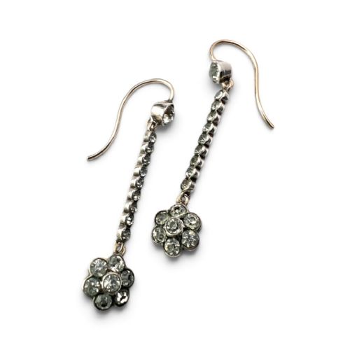 A pair of antique drop earrings featuring a linear row of round faceted paste stones terminating in a flower cluster drop. View III
