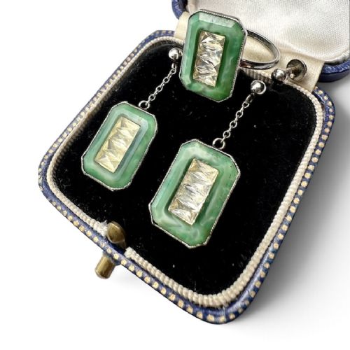 fig 1. An Art Deco silver jewellery set featuring a rectangular ring and matching drop earrings inset with green glass plaques and clear step-cut paste stones.