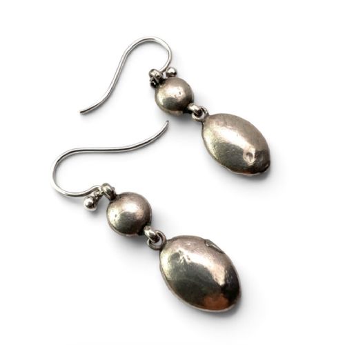 fig 1. A pair of antique silver drop earrings featuring oval light blue paste central stones surrounded by clear paste halos suspended from wire hooks.