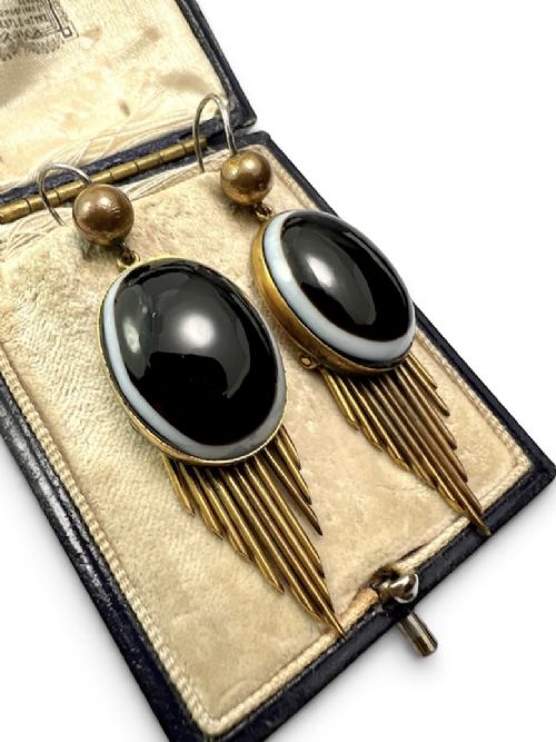 A pair of Victorian drop earrings featuring oval bullseye agate cabochons set in gold frames with graduating metallic fringe spikes below. View III