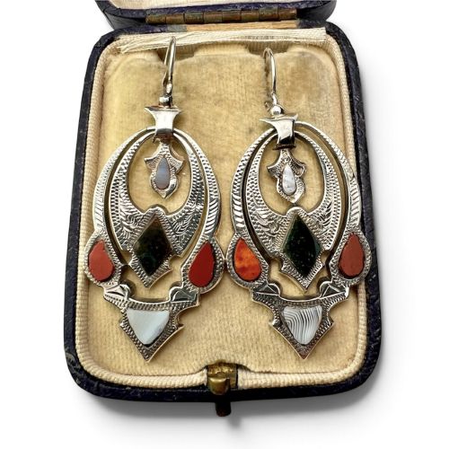 fig 1. A pair of Victorian sterling silver drop pendant earrings featuring hand-engraved openwork panels inlaid with geometric red jasper, green moss agate, and grey banded agate stones.