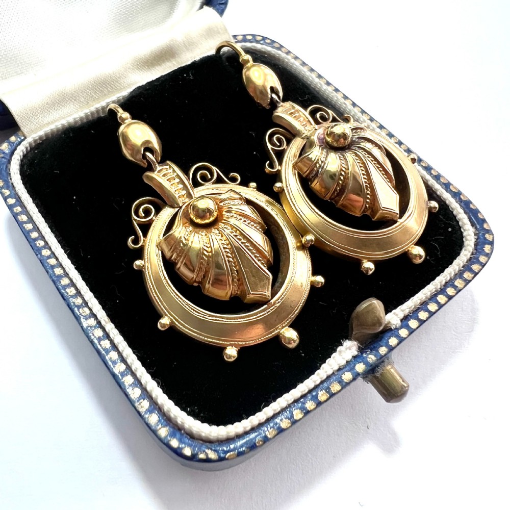 A pair of Victorian 18ct yellow gold drop earrings featuring detailed acanthus leaf motifs suspended within circular outer hoops. View II