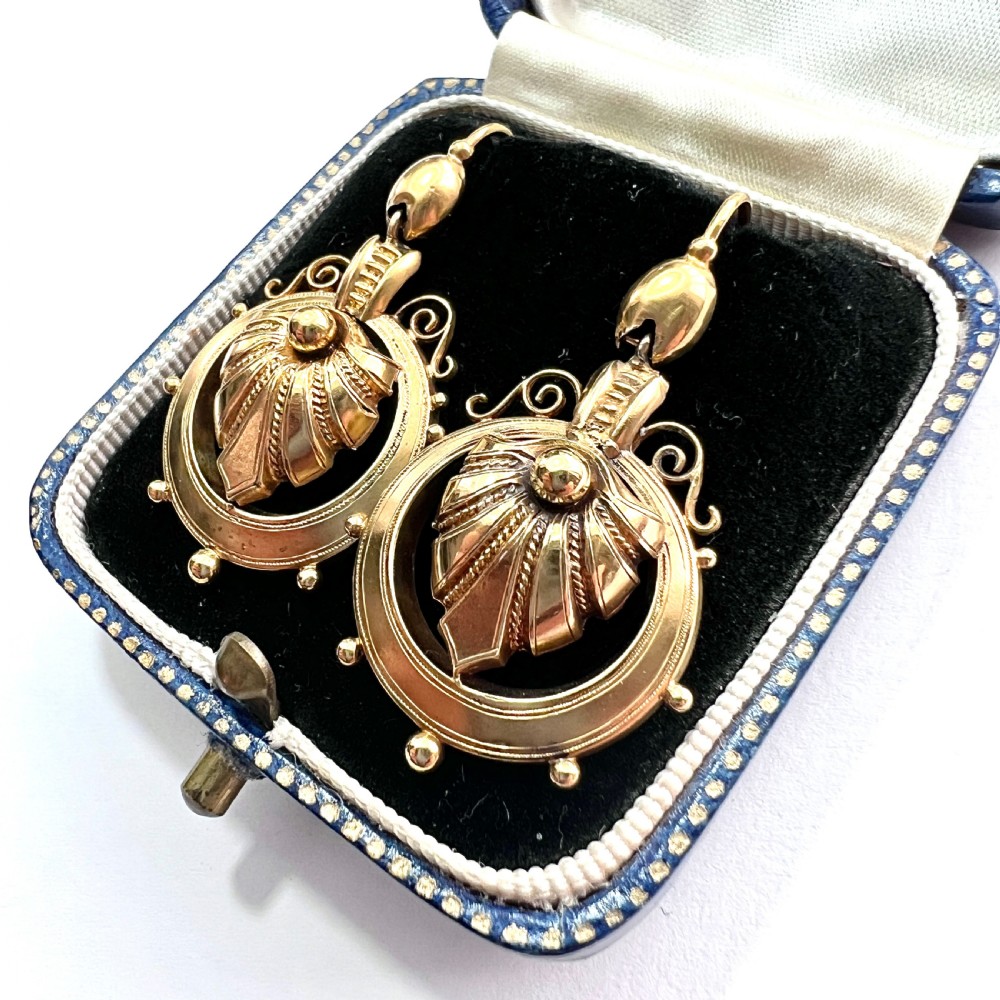 A pair of Victorian 18ct yellow gold drop earrings featuring detailed acanthus leaf motifs suspended within circular outer hoops. View III