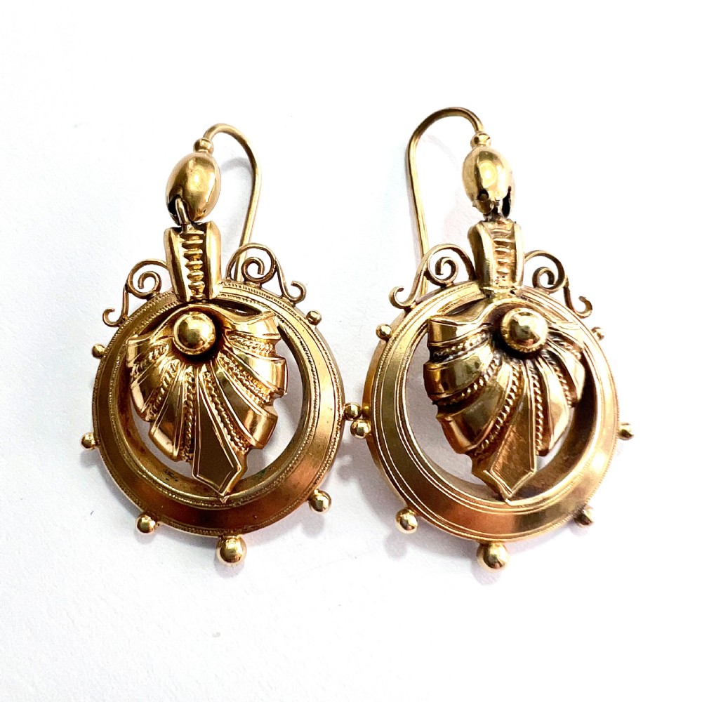 A pair of Victorian 18ct yellow gold drop earrings featuring detailed acanthus leaf motifs suspended within circular outer hoops. View XII