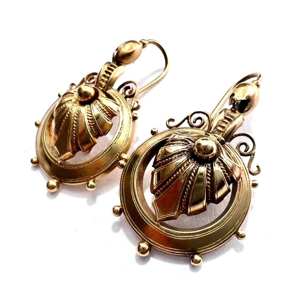 A pair of Victorian 18ct yellow gold drop earrings featuring detailed acanthus leaf motifs suspended within circular outer hoops. View XIV
