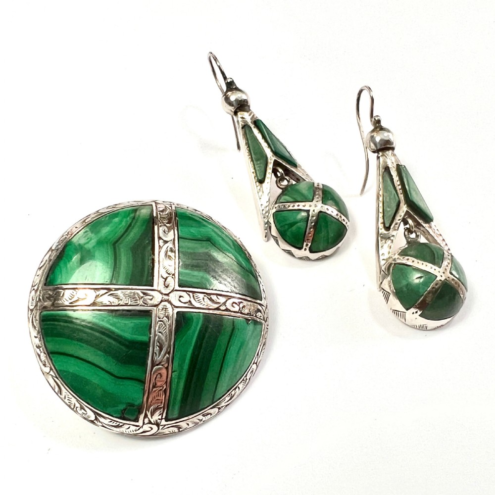 A Victorian Scottish silver jewellery suite comprising a circular brooch and drop earrings inlaid with banded green malachite. View II