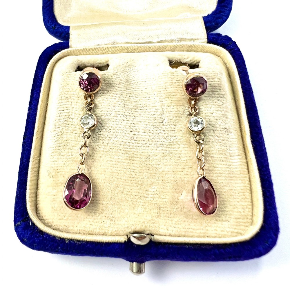 A pair of Edwardian 9ct yellow gold drop earrings set with faceted pink tourmalines and small round rock crystal accents. View II