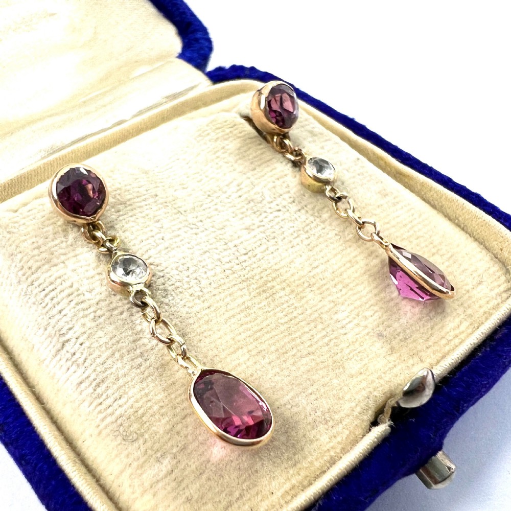 A pair of Edwardian 9ct yellow gold drop earrings set with faceted pink tourmalines and small round rock crystal accents. View III