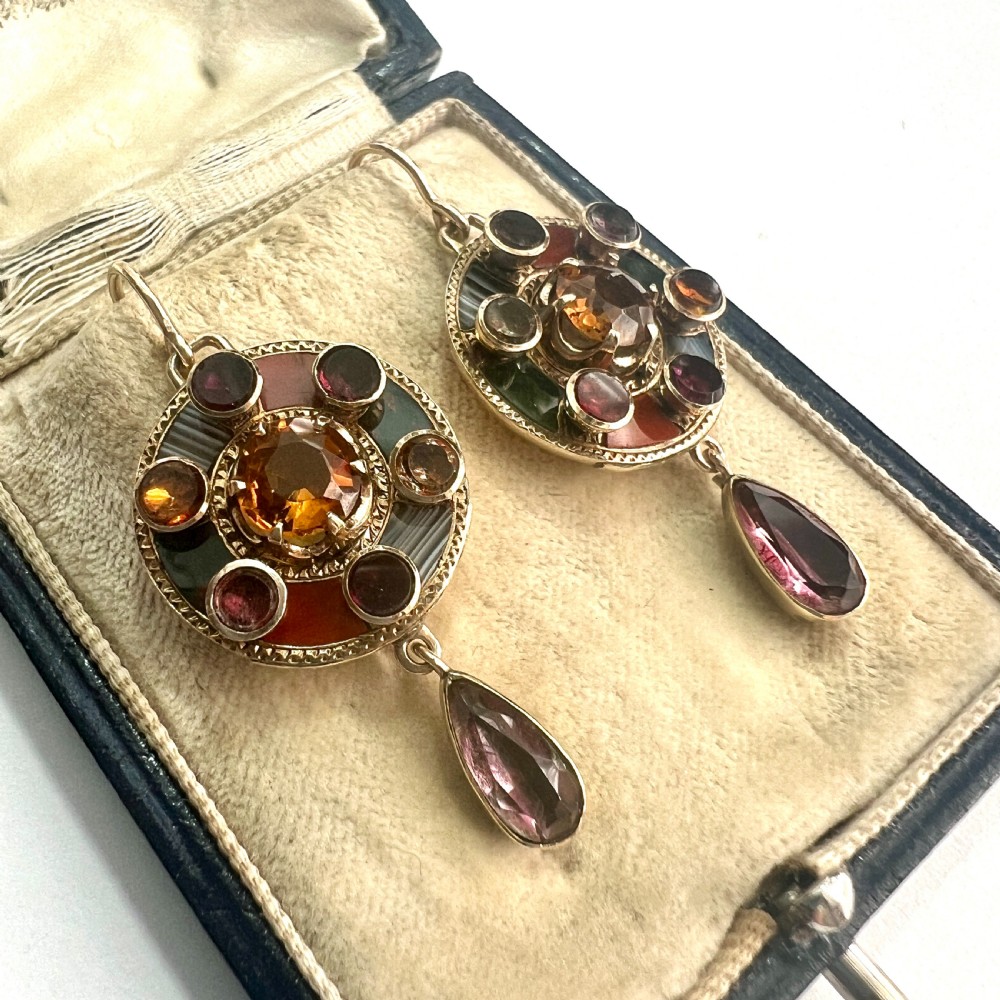 A pair of Victorian 9ct gold target drop earrings inlaid with patterned agates and surrounding central citrine gemstones. View II